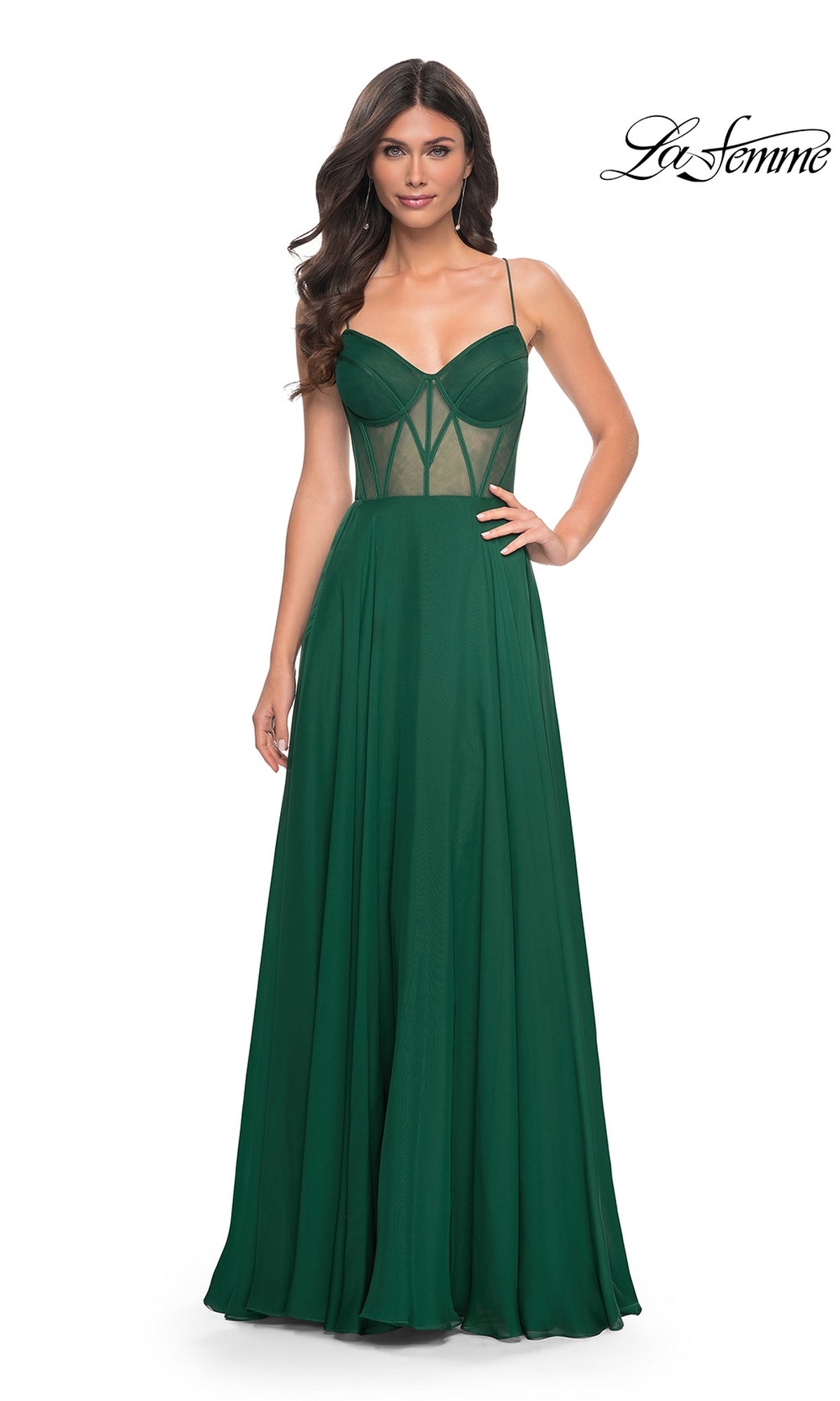 Woman wearing the La Femme Sheer-Waist Long A-Line Prom Dress 32296 in emerald green, featuring thin straps, mesh corset bodice panels, and a fitted waist, standing against a white background.